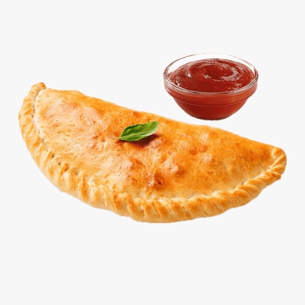 Golden-brown calzone with a basil leaf on top, next to a small bowl of red sauce.